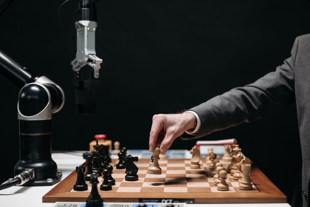 a-person-playing-chess-8438944 A robotic arm plays chess against a human, symbolizing AI innovation and strategy.